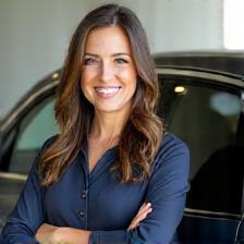 Kelsey standing next to spotless sedan